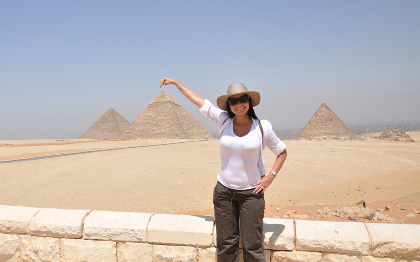 Woman touching pyramids, Giza