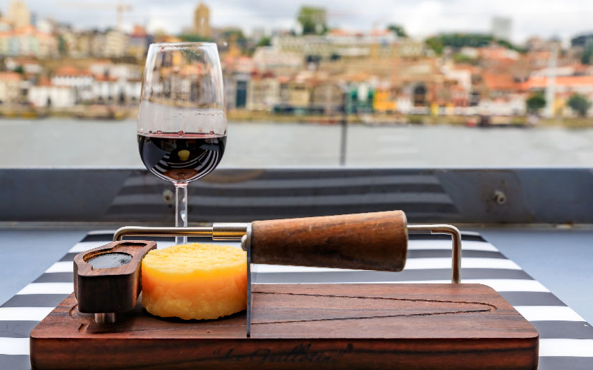 port wine and cheese with the blurred cityscape of Porto