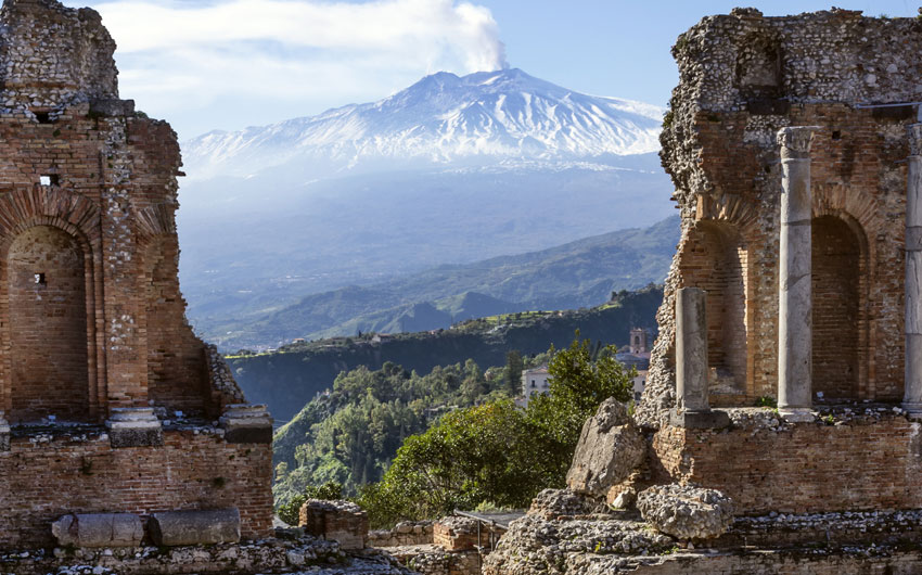 Etna seen through the Ancient Amphitheater in Taormina