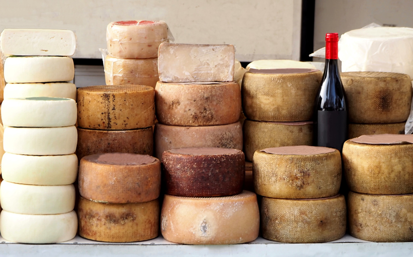 Cheese wheels of Pecorino and Sardinian ricotta in different stacks