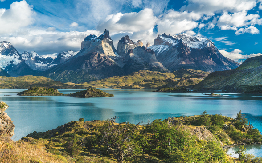 Blue Lake on a Snowy Mountains Background and Cloudy Sky, Torres del paine