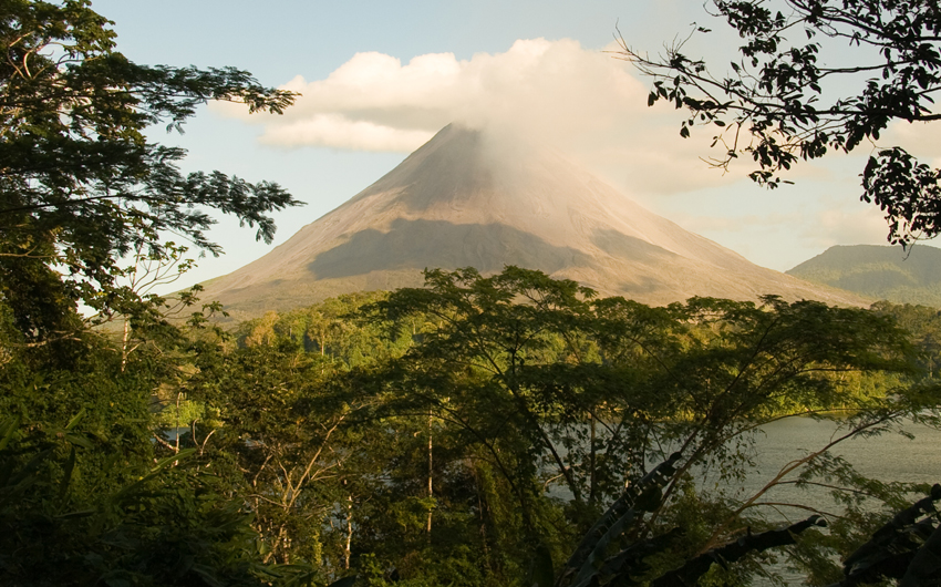 Arenal Volcano through the trees and over Lake Arenal