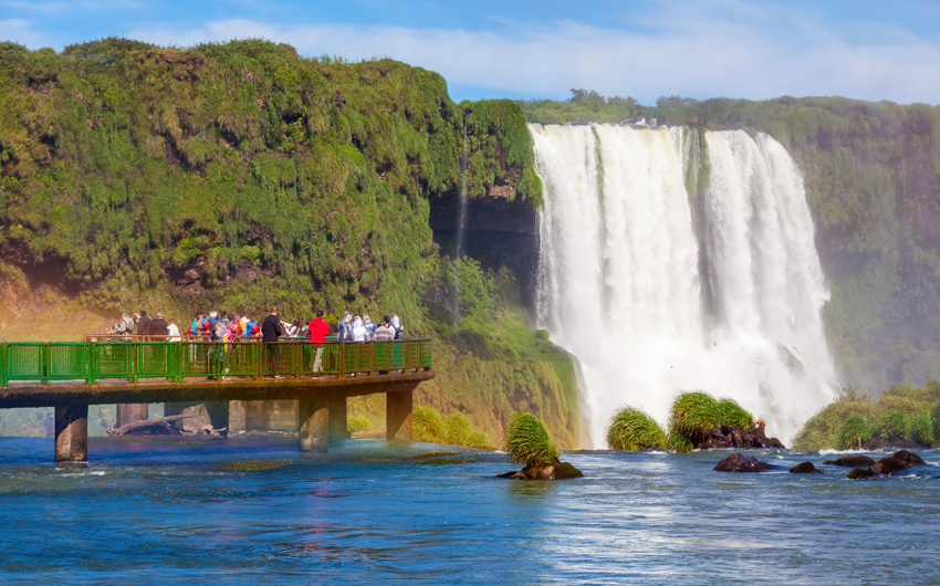 Tourists near the Iguazu Falls, waterfalls of the Iguazu River on the border of the Argentina and the Brazil