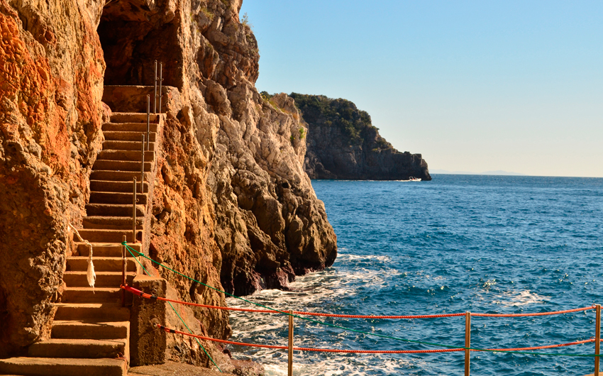 Stone stairs cut into the sea cliff along the Amalfi Coast