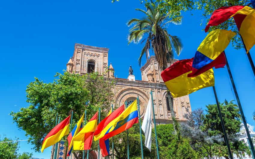 Flags waving in front of the cathedral in the historic center of Cuenca