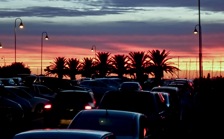 Beautiful sunset in a street full of cars in Punta de Este